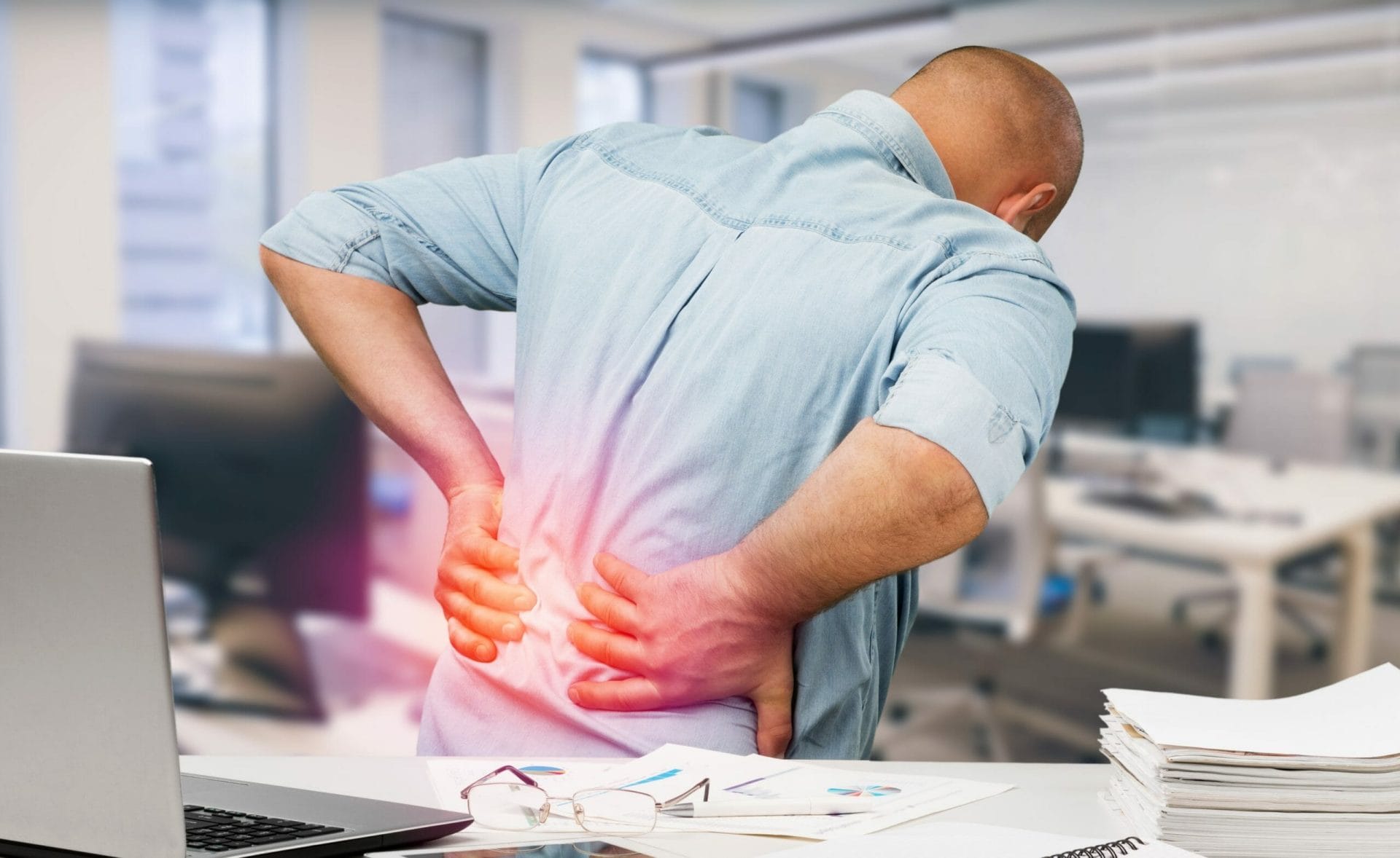 Man with back pain in office