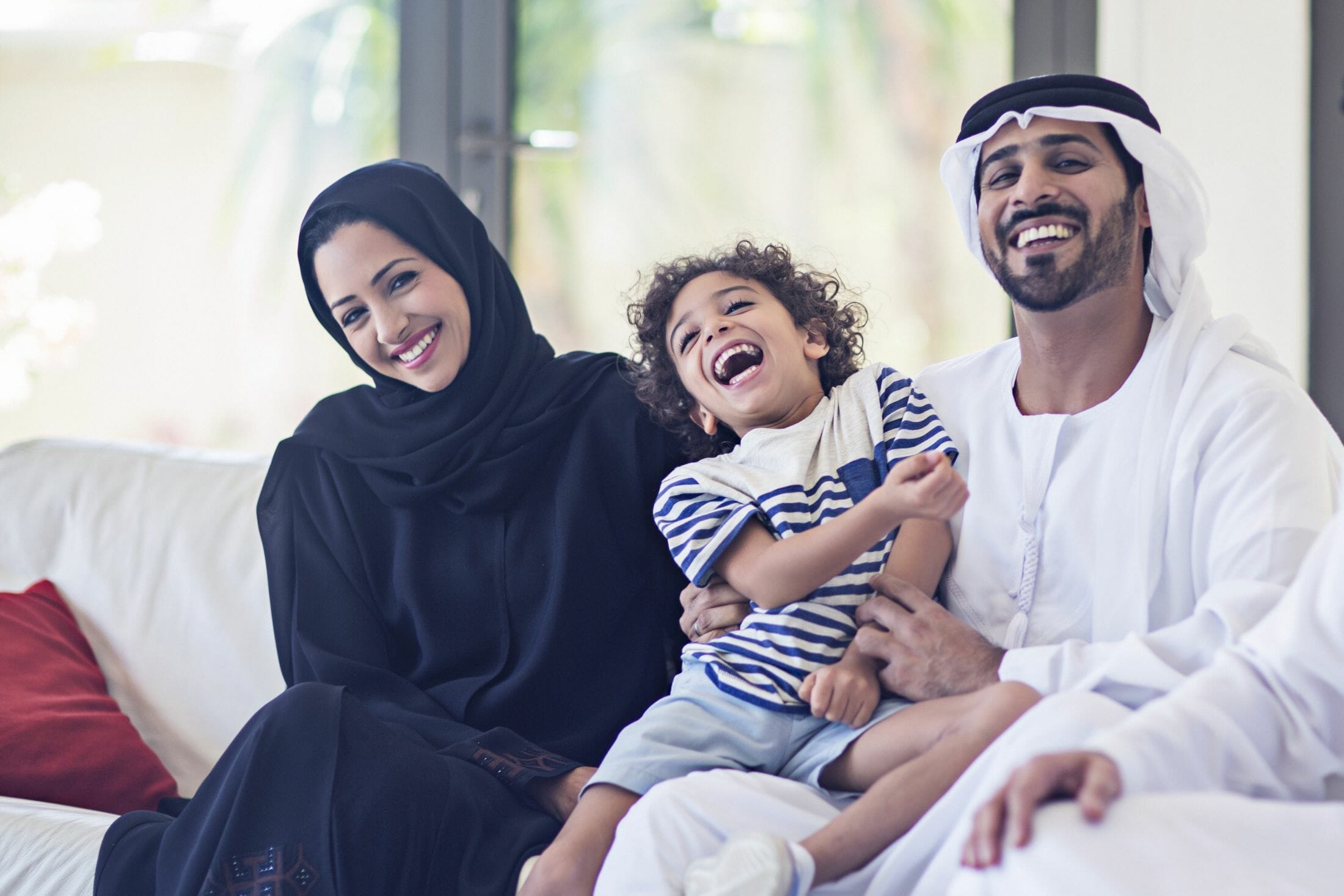 Portrait of a middle eastern family looking at the camera.